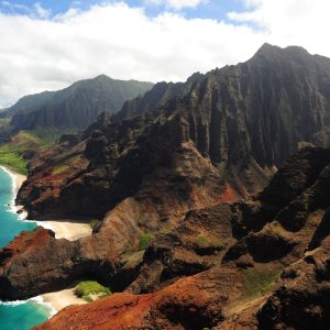 a body of water with Nā Pali Coast in the background