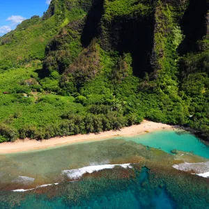 a body of water with a lush mountain behind it