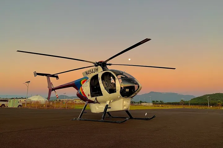 a plane sitting on top of a helicopter