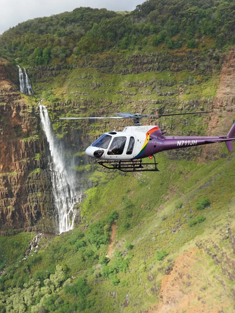 Helicopter tour over a Kauai waterfall