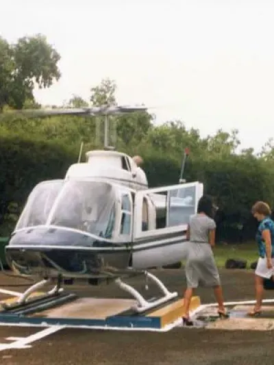 women climbing onto a helicopter