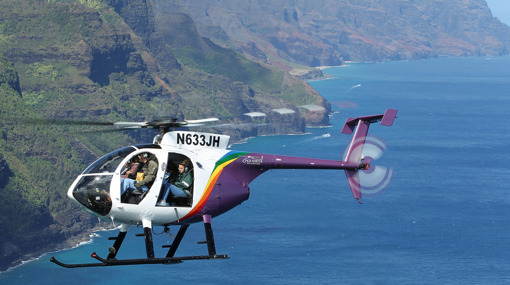 a person flying through the air on a mountain lake