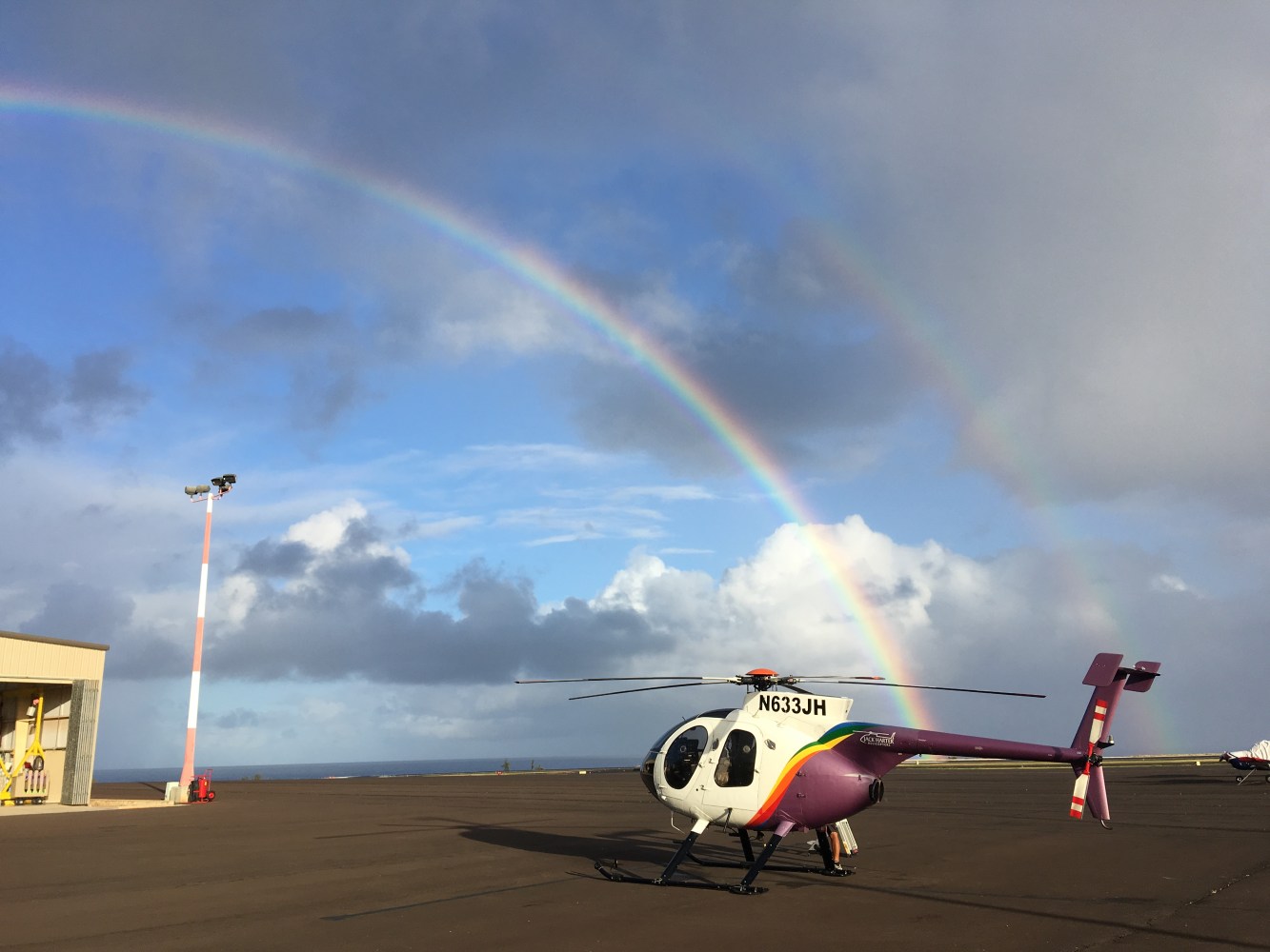 a plane with a rainbow in the background