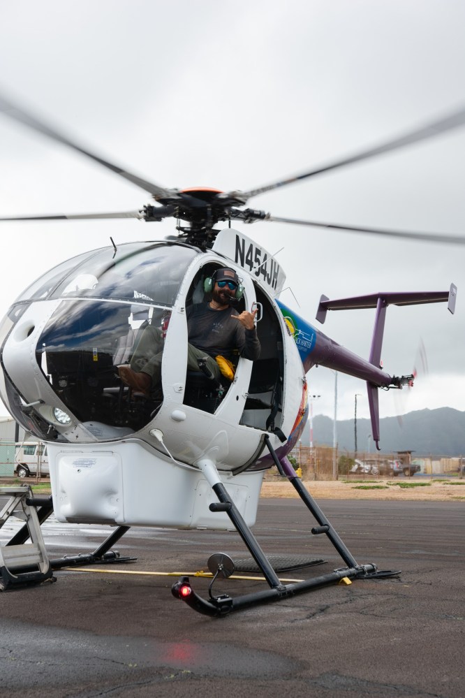 a small plane sitting on top of a helicopter